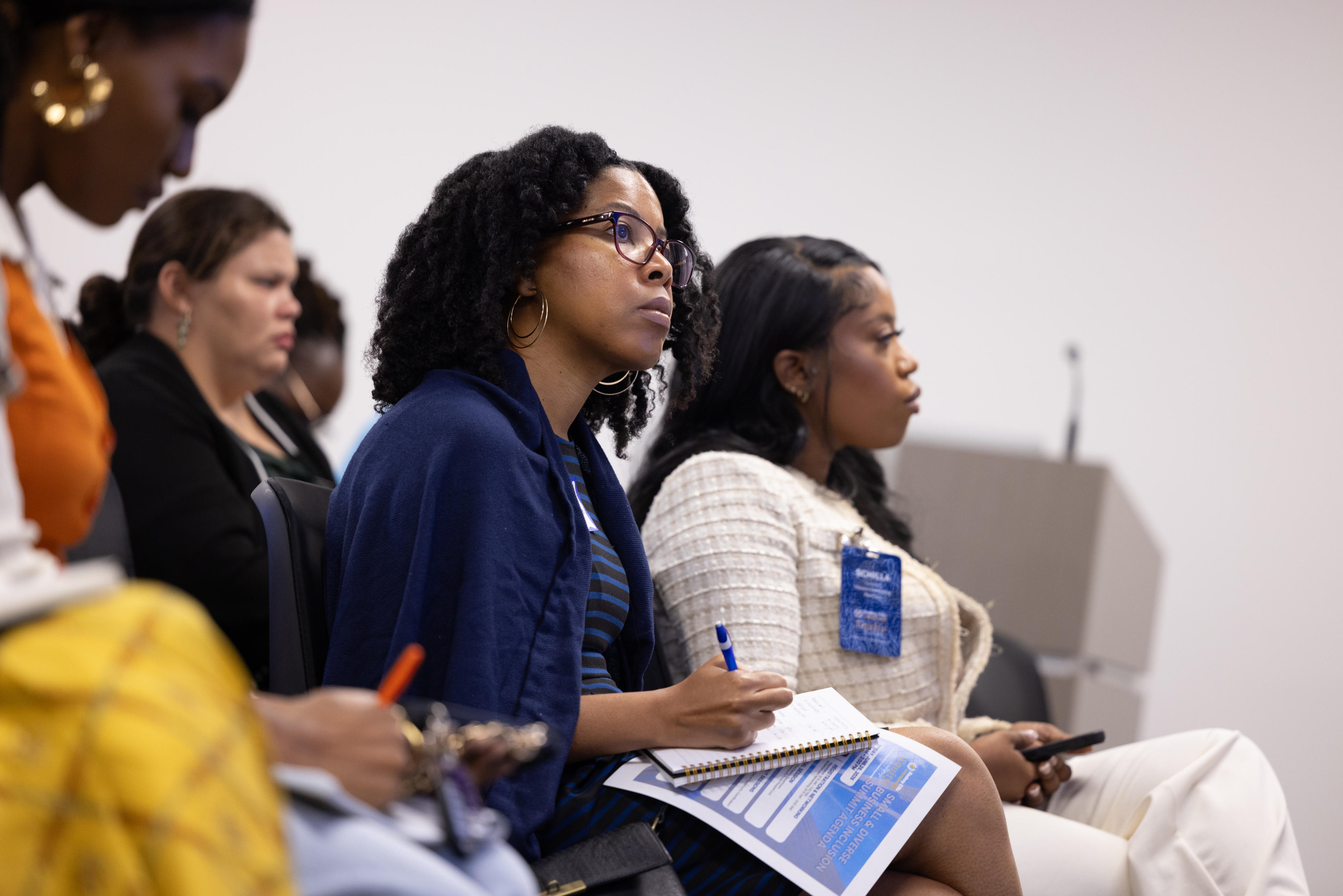 Attendees taking notes during a session at the Small & Diverse Business Inclusion Summit